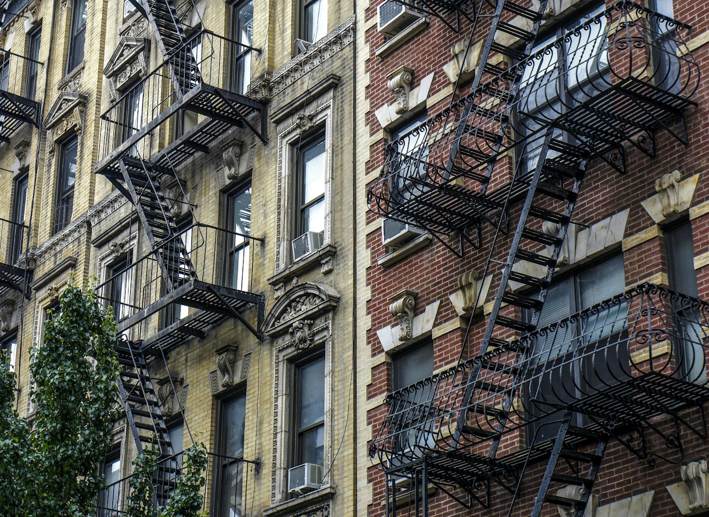 Urban residential buildings with fire escapes and architectural details